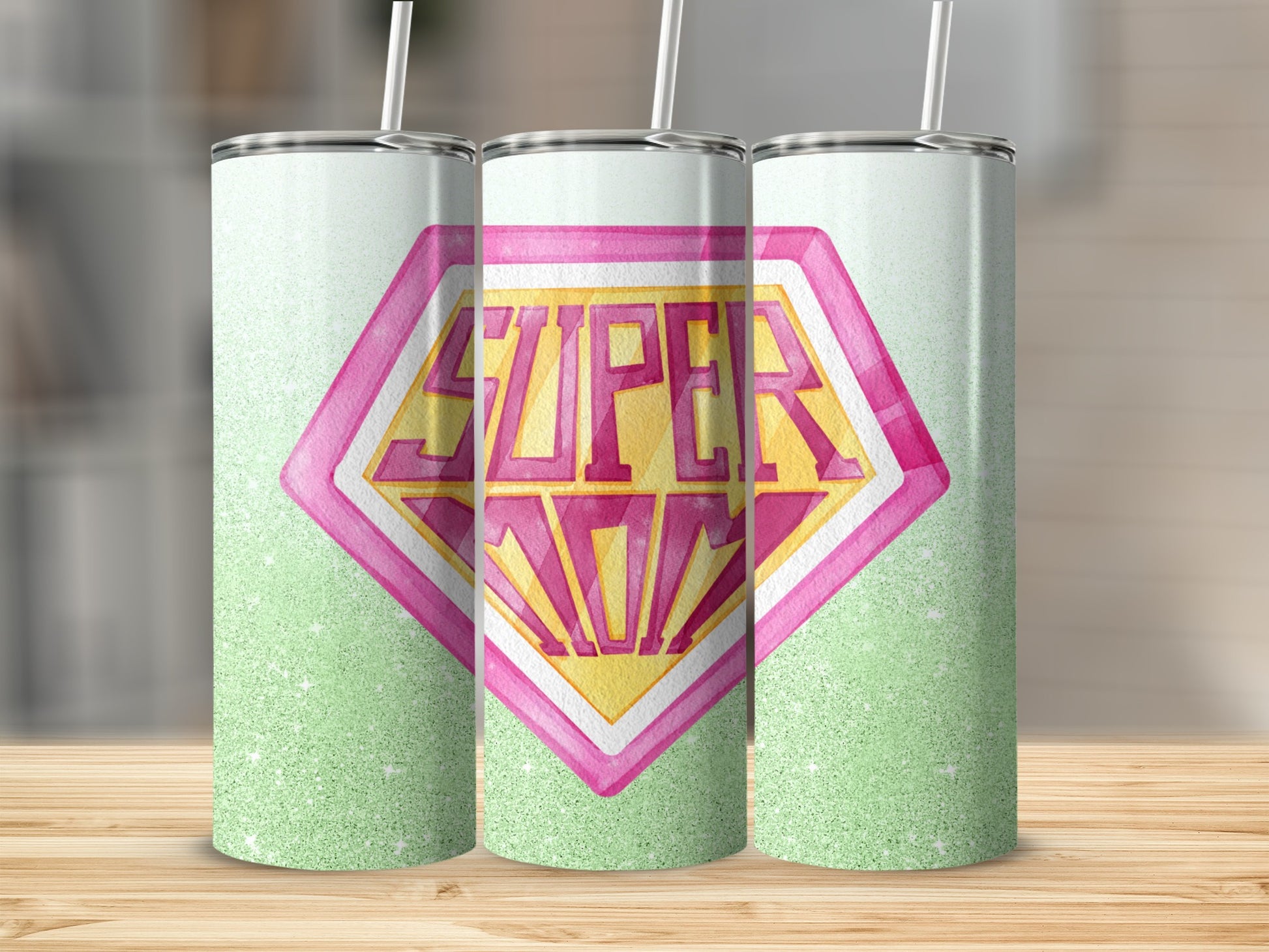 Superhero "Super Mom" logo on a green glitter tumbler.