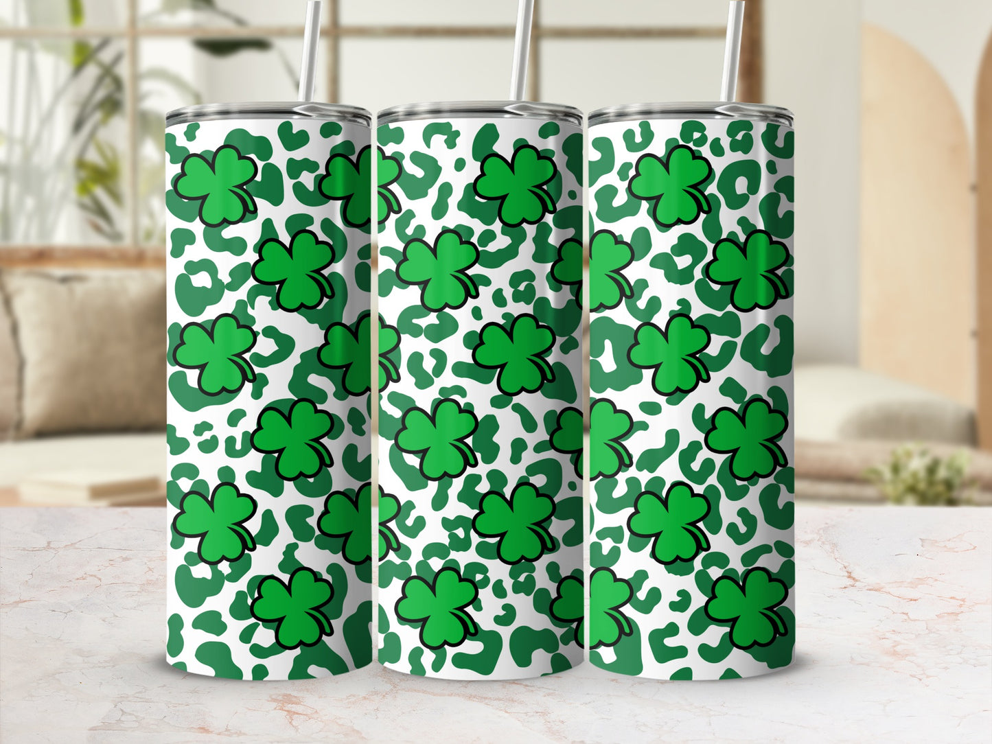 Green shamrocks and leopard print pattern on three tumblers.
