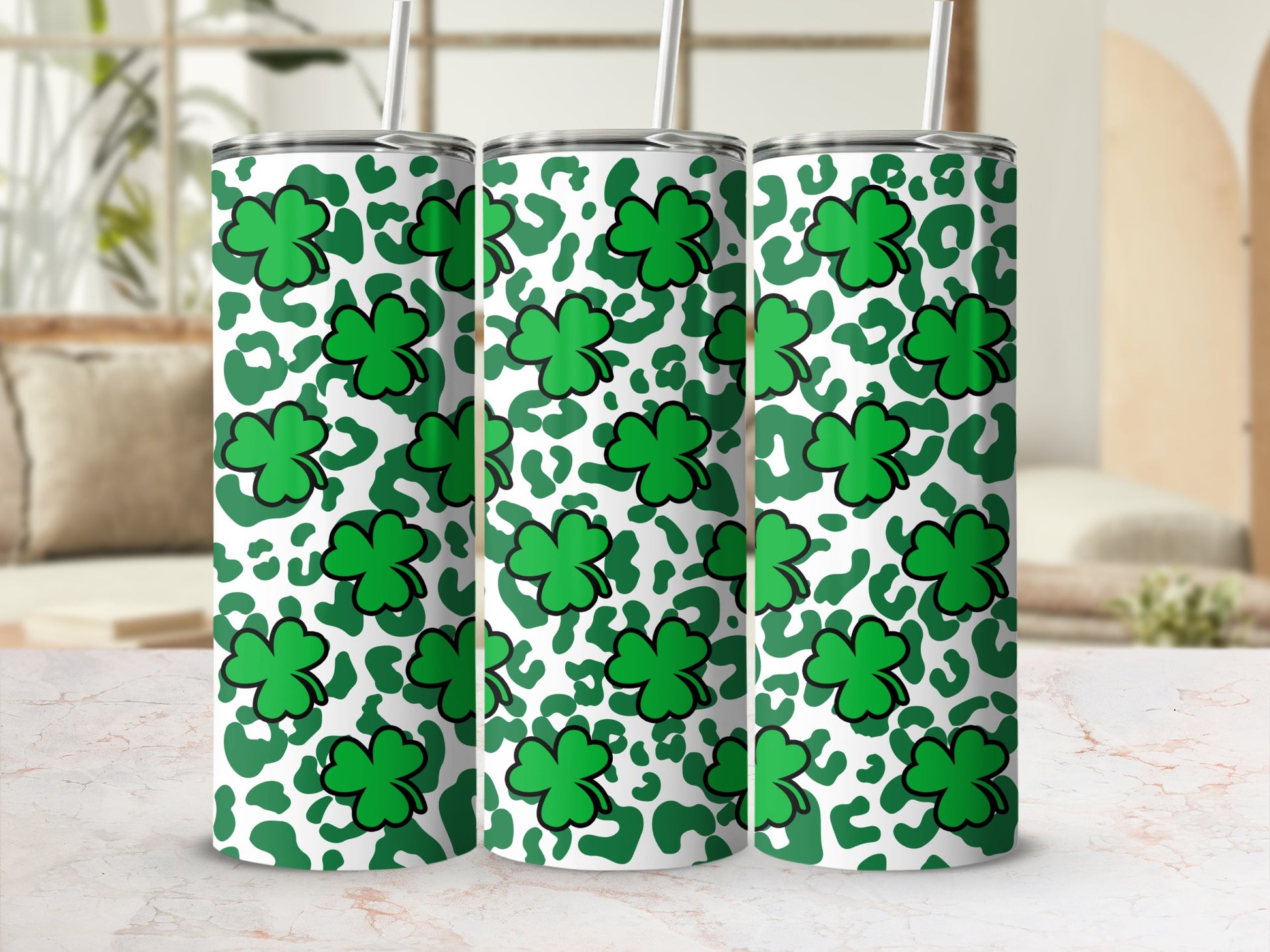 Green shamrocks and leopard print pattern on three tumblers.