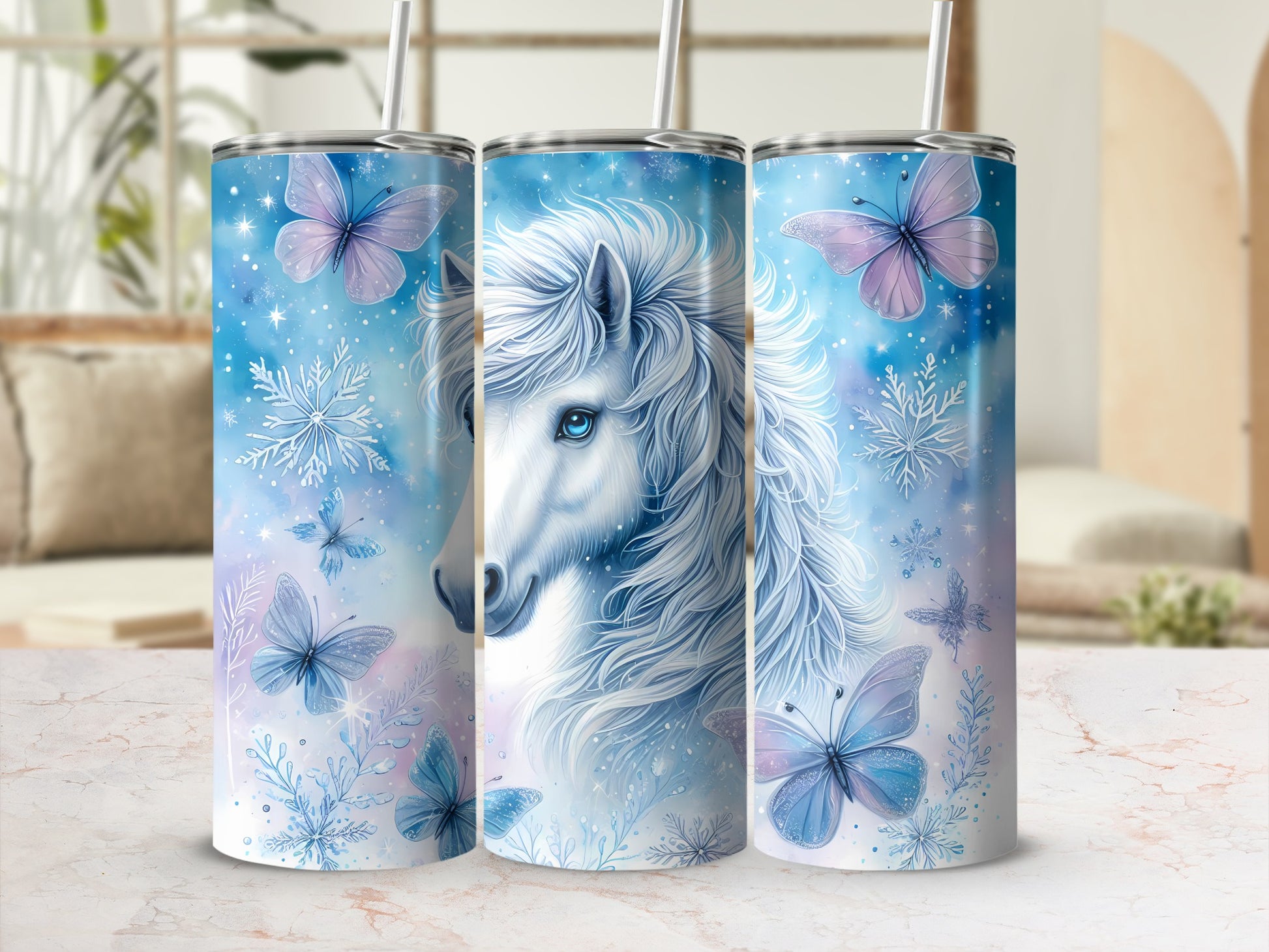 Blue watercolor unicorn with butterflies and snowflakes on a tumbler.