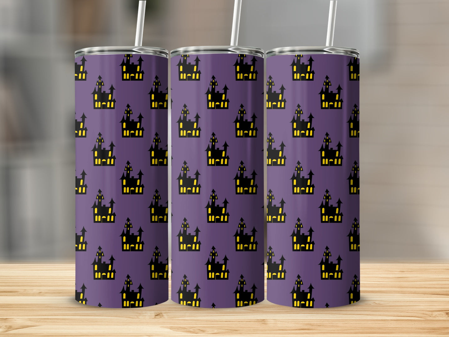 Purple tumbler with repeating pattern of black and yellow haunted castles.