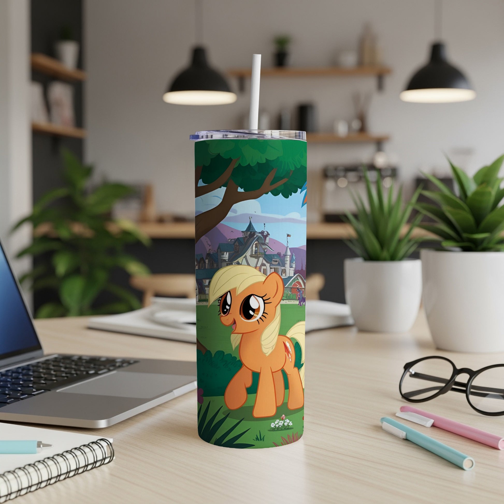 Applejack from My Little Pony on a colorful tumbler on a desk.