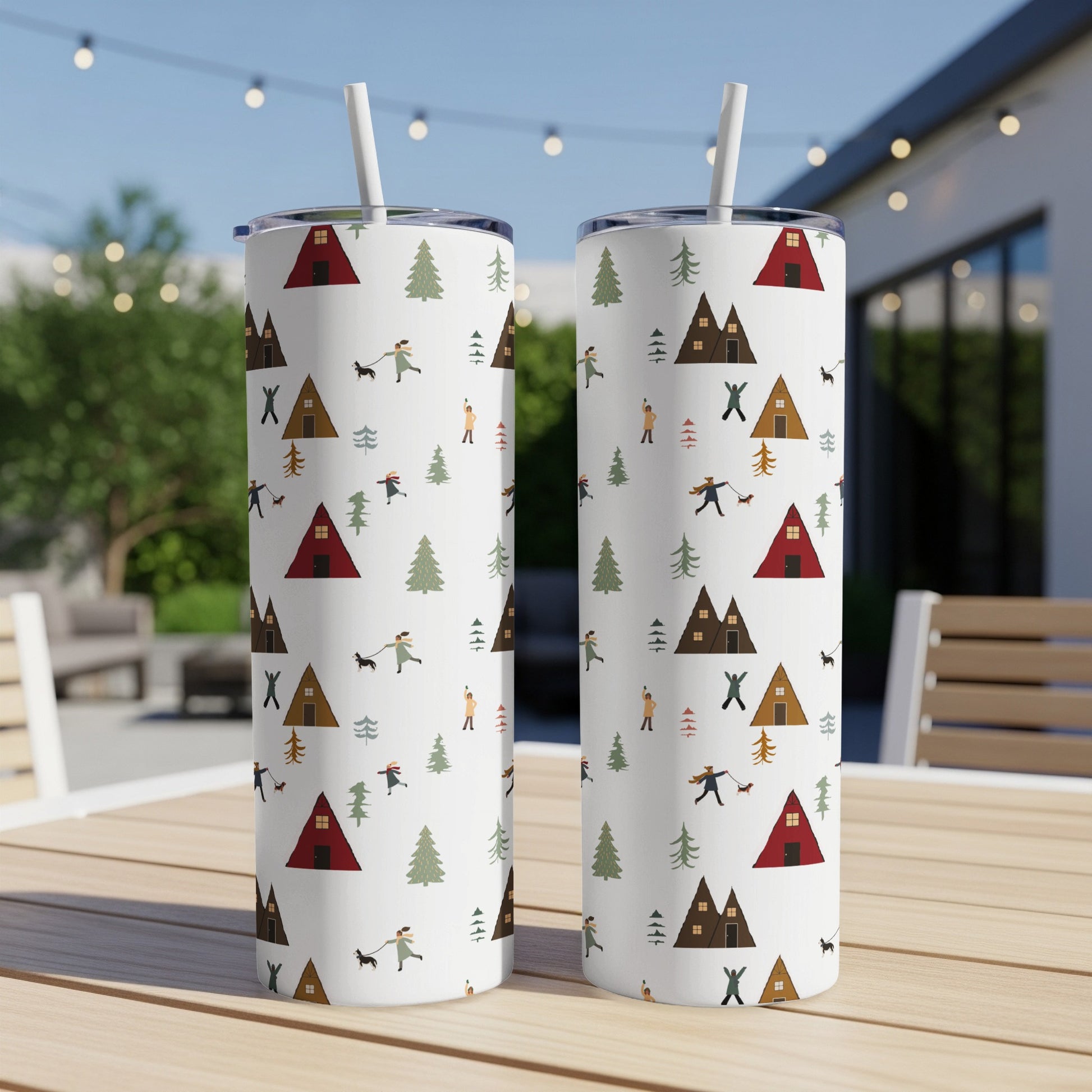 Two tall tumblers with a pattern of tents, trees, and people walking dogs.