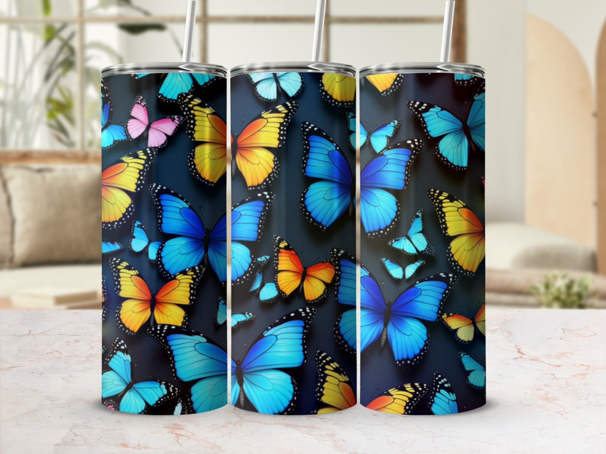 Three tumblers decorated with colorful butterfly patterns.