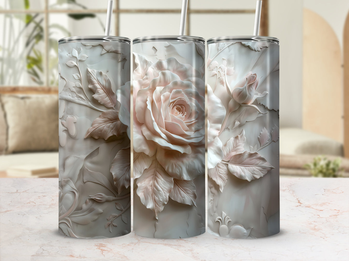 Three floral-embossed tumblers with lids and straws in a soft blush pink.