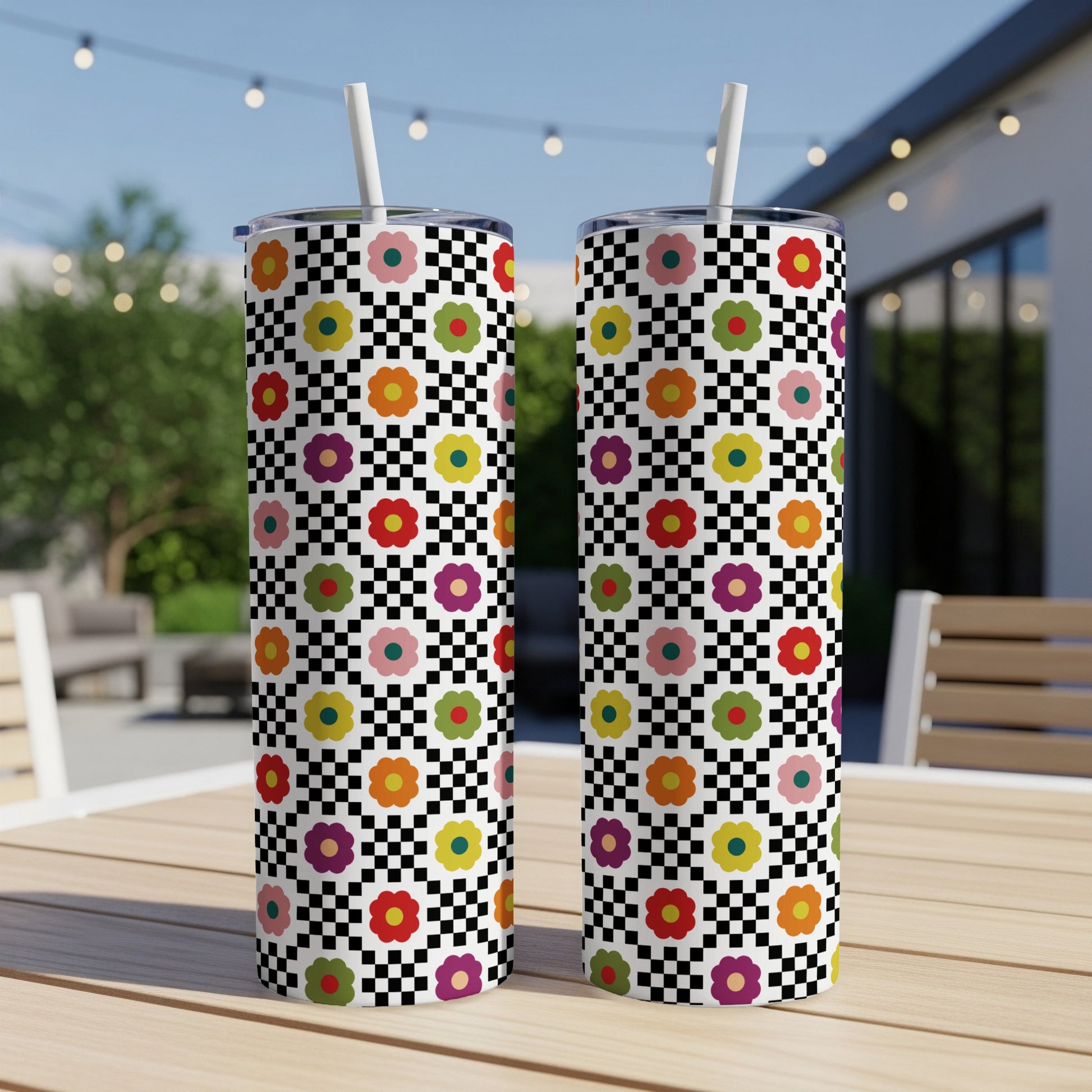 Two tall tumblers with a checkered pattern and colorful floral graphic design.