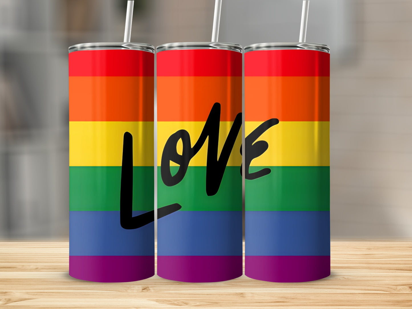 Three tumblers with rainbow stripes and the word "love" in black.
