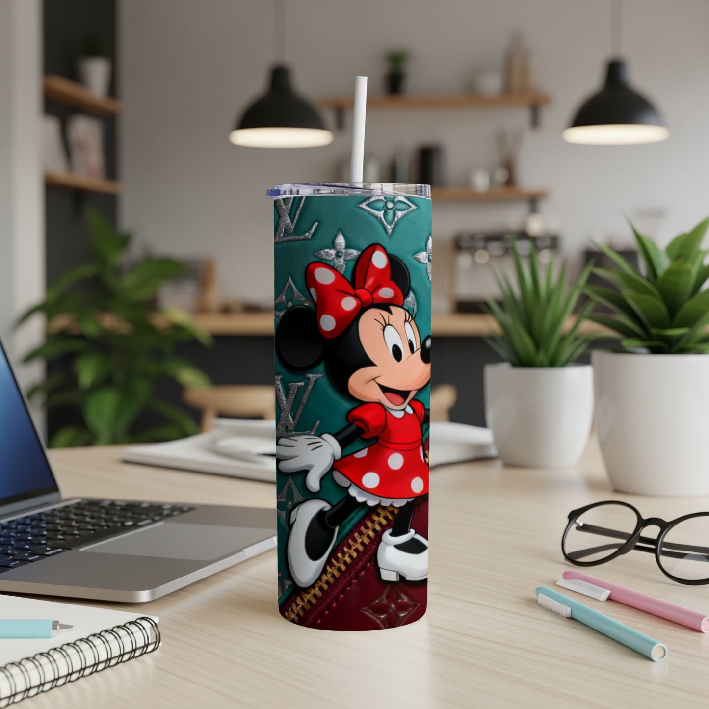 Minnie Mouse on a teal tumbler with red polka dot dress and bow.