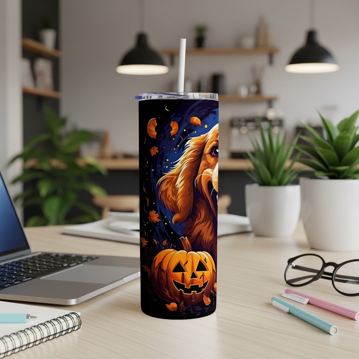 Tumbler with a Halloween dog and jack-o'-lantern design on a desk.