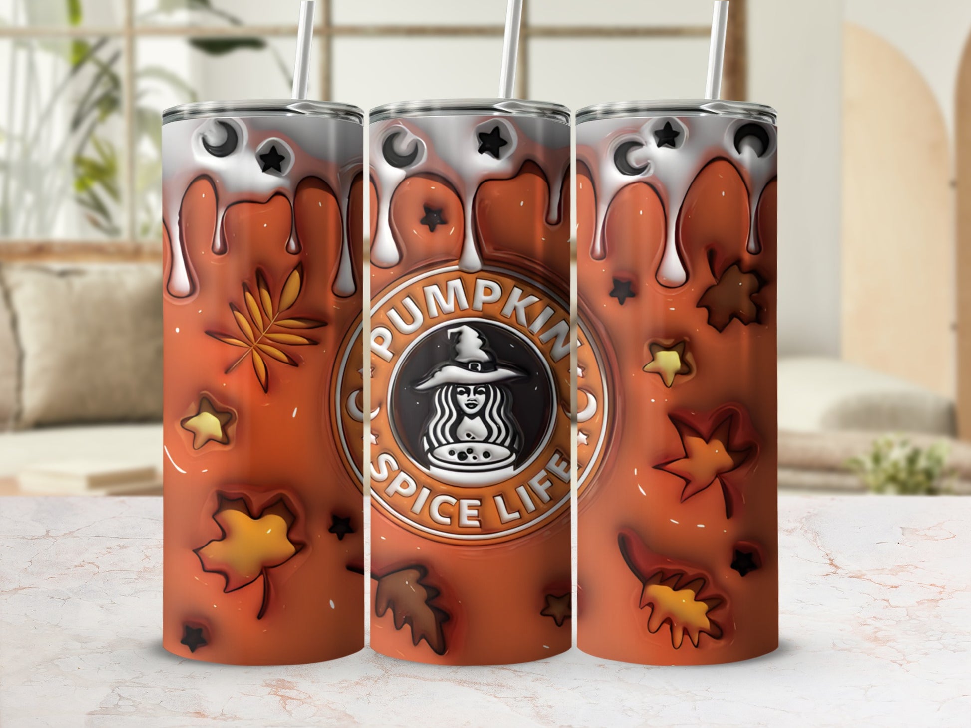 Three tumblers with pumpkin spice design and autumn leaves.