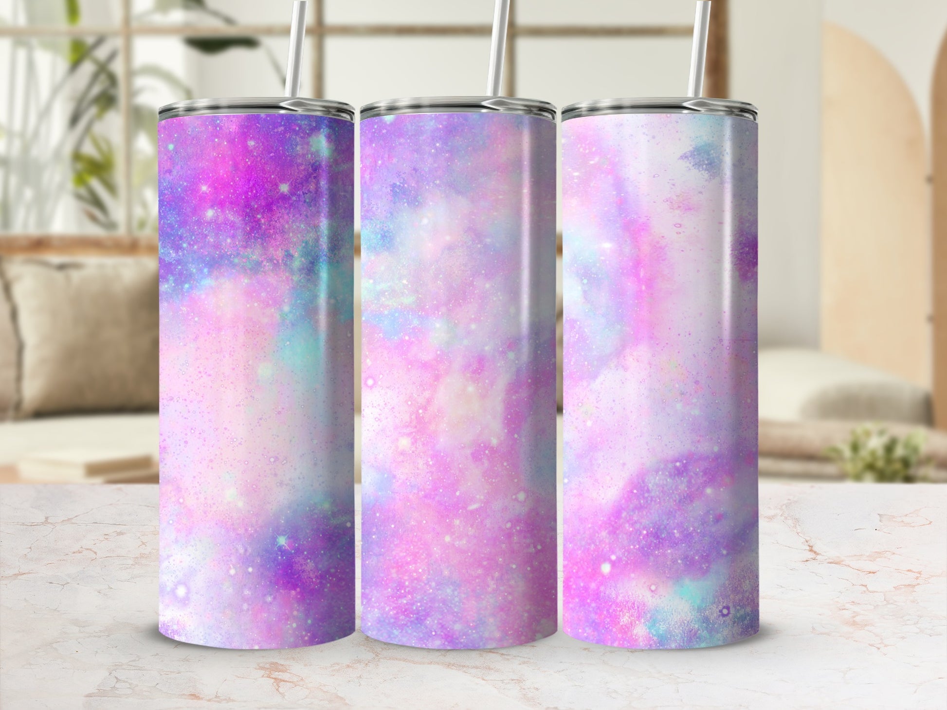 Three tumblers with a purple, pink, and teal galaxy watercolor design.