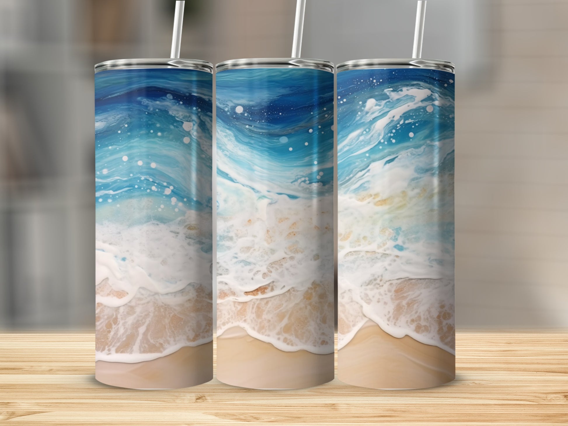 Three tumblers with a swirling ocean wave and sandy beach design.