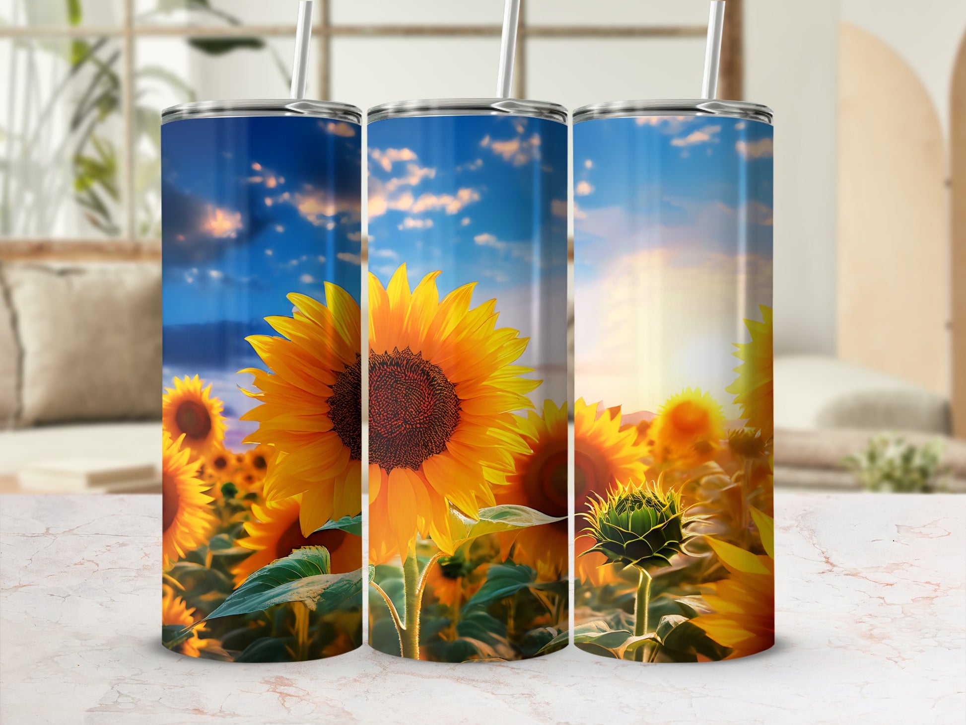 Three tumblers featuring sunflowers against a sunset sky.