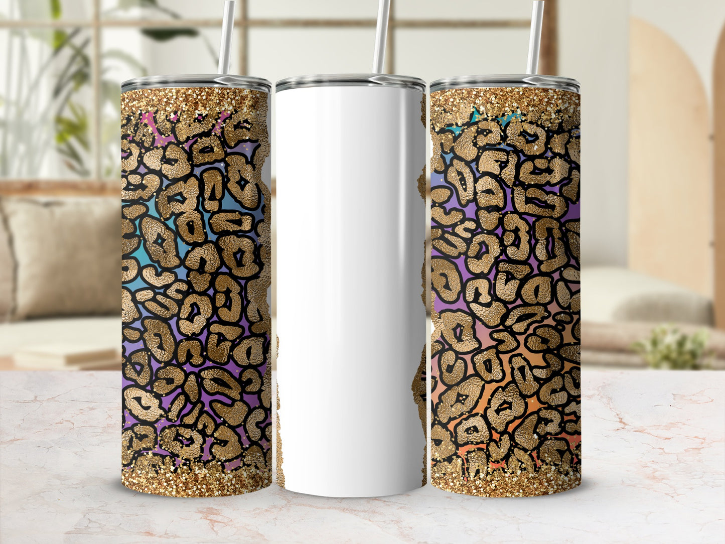 Three tumblers with leopard print and glitter accents on a marble surface.