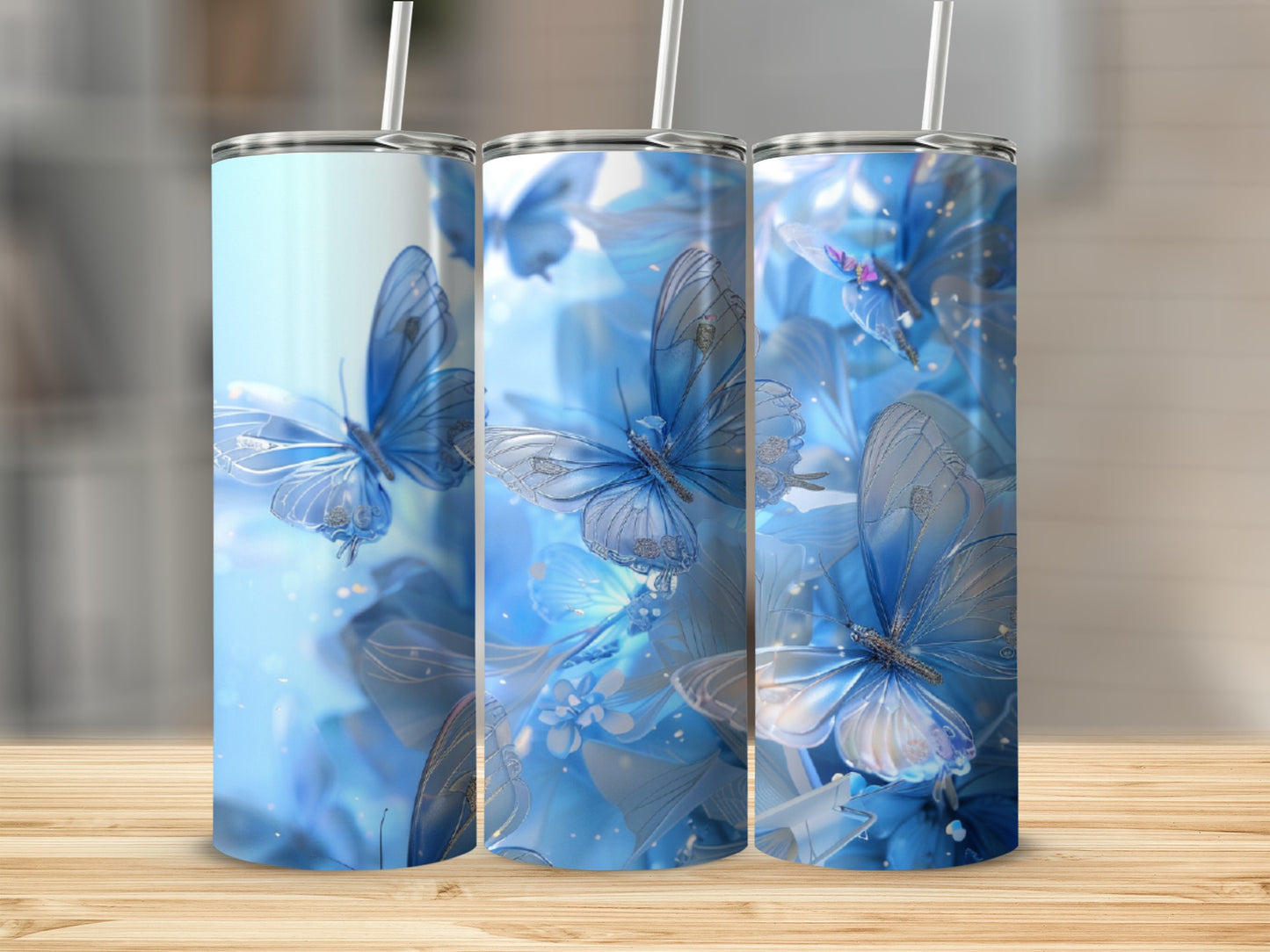 Three blue tumblers with butterfly and floral designs.