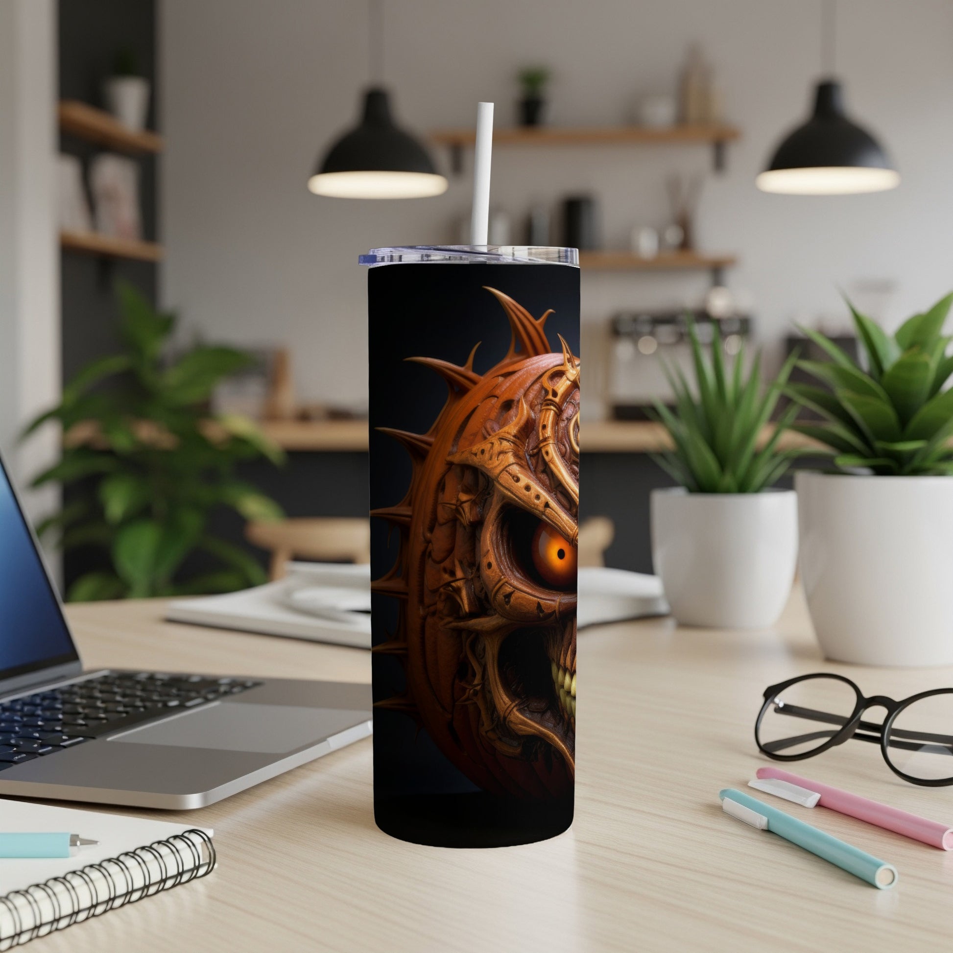 Tumbler with a creepy, spiky pumpkin skull design and an orange glowing eye.