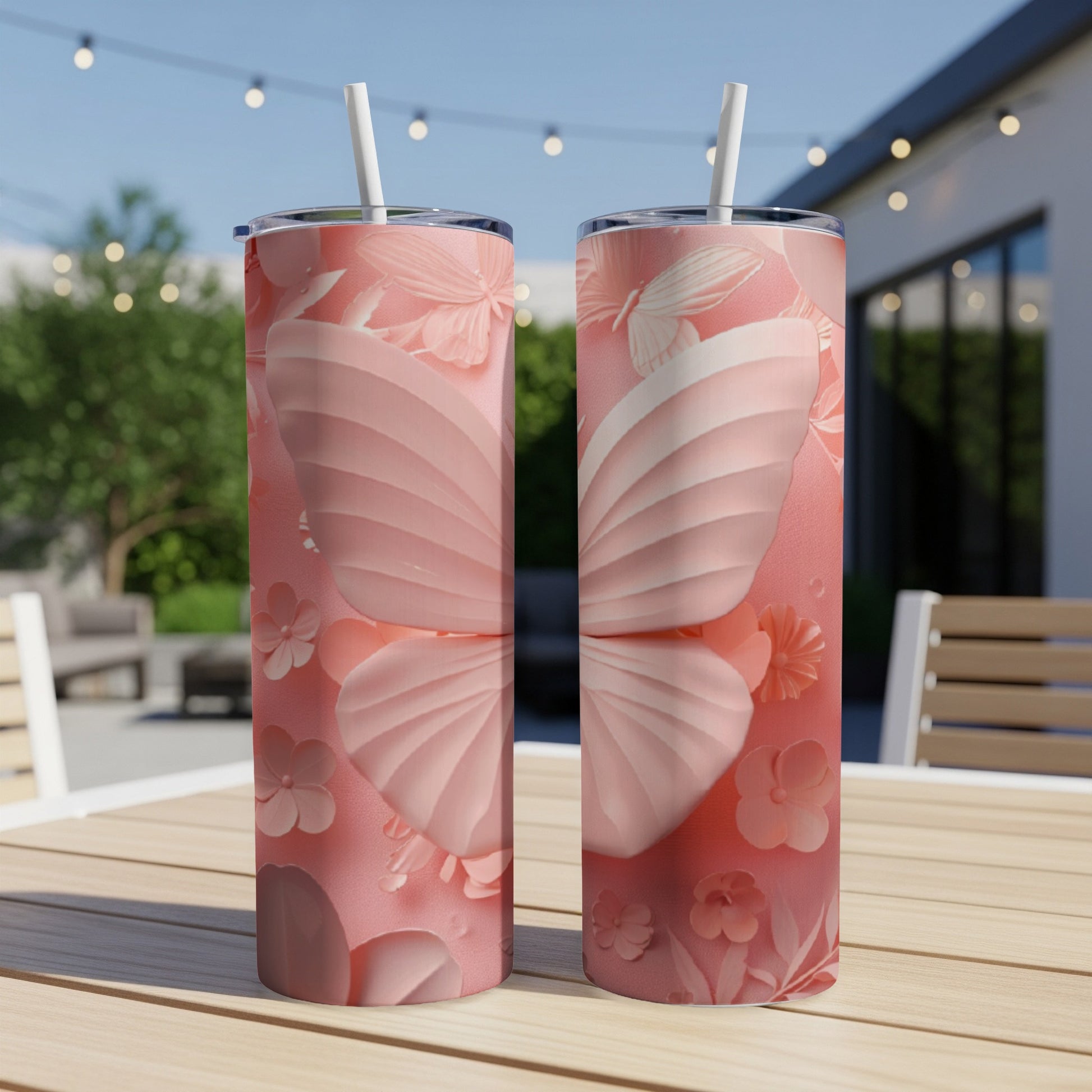Two pink tumblers with butterfly and floral embossed designs.