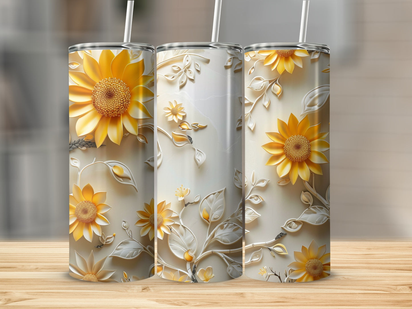 Three tumblers with embossed sunflowers and floral patterns.
