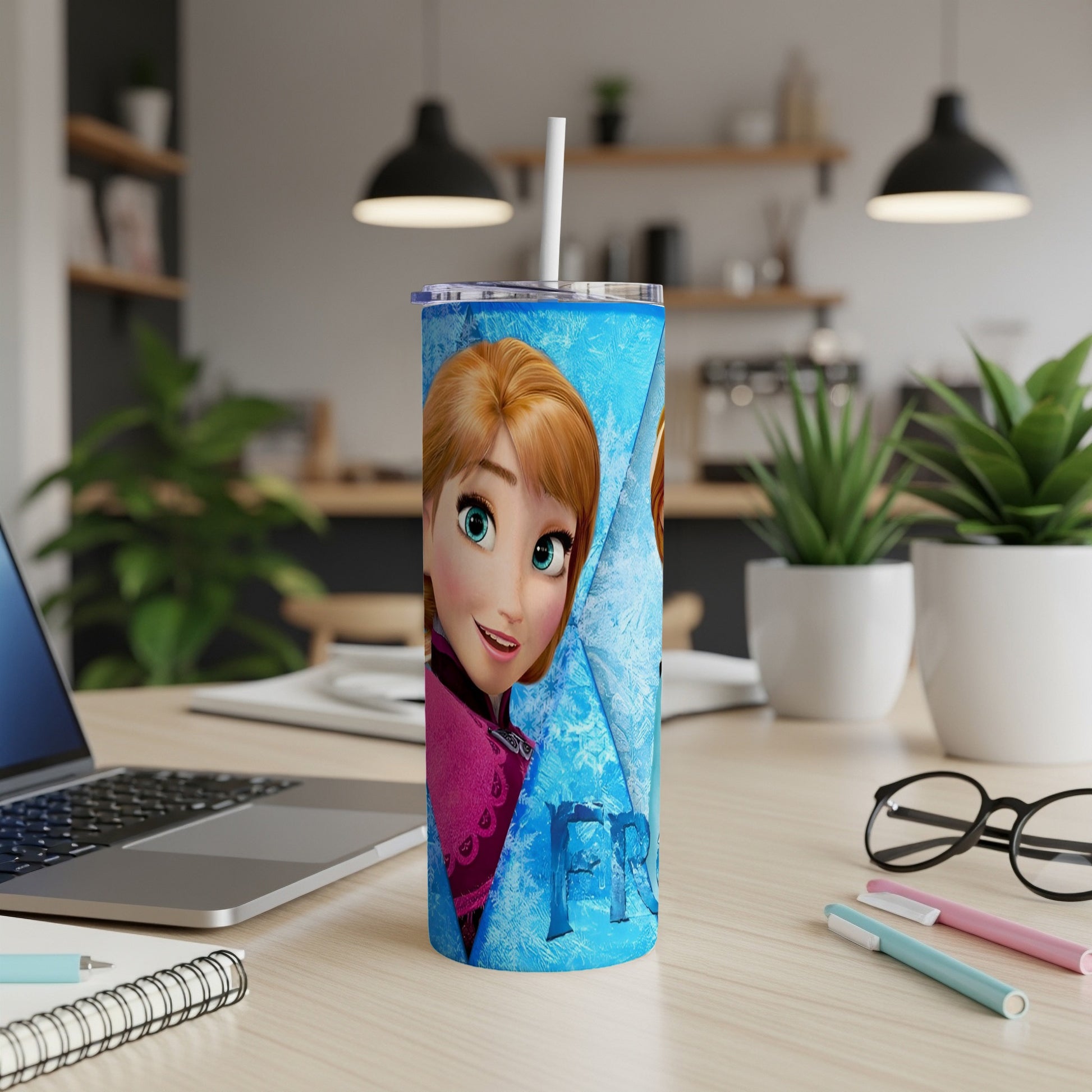 Frozen Anna tumbler with white straw on a desk.