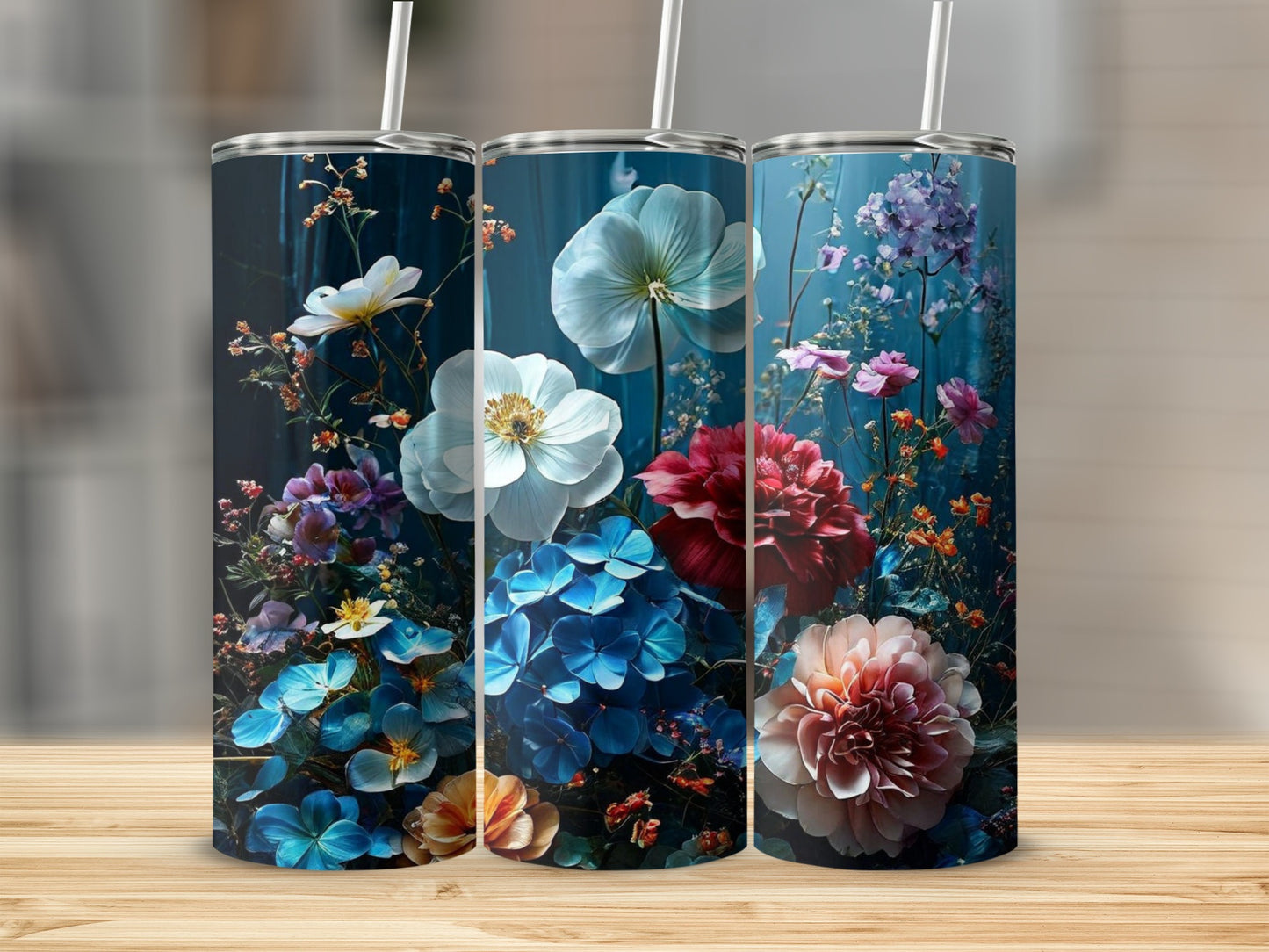 Three tumblers with dark floral designs featuring white, blue, and pink flowers.