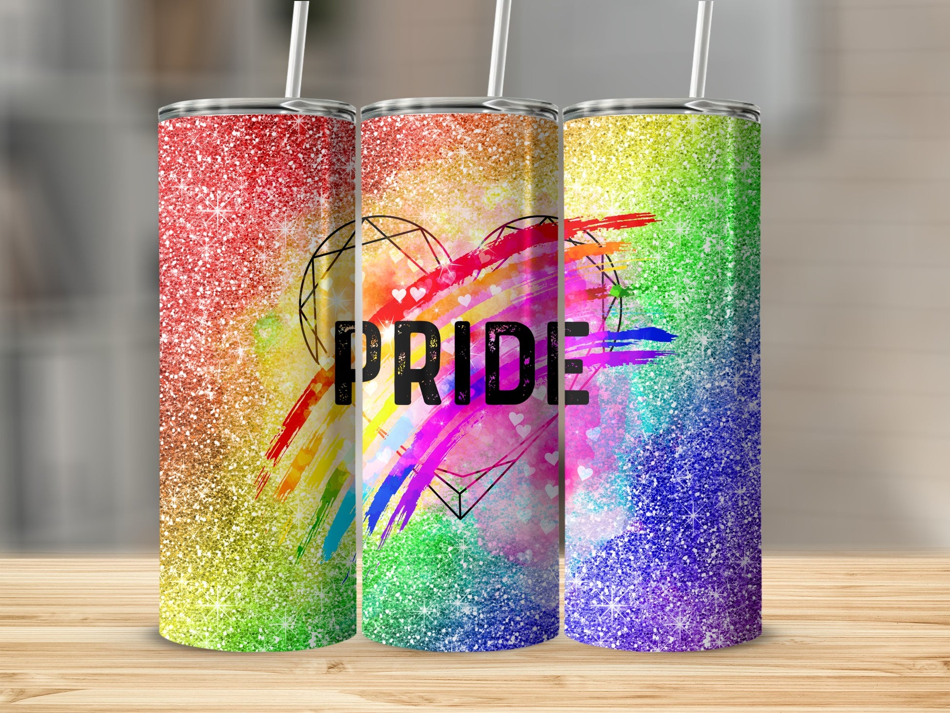 Three glitter tumblers with rainbow stripes and "Pride" text inside a heart outline.