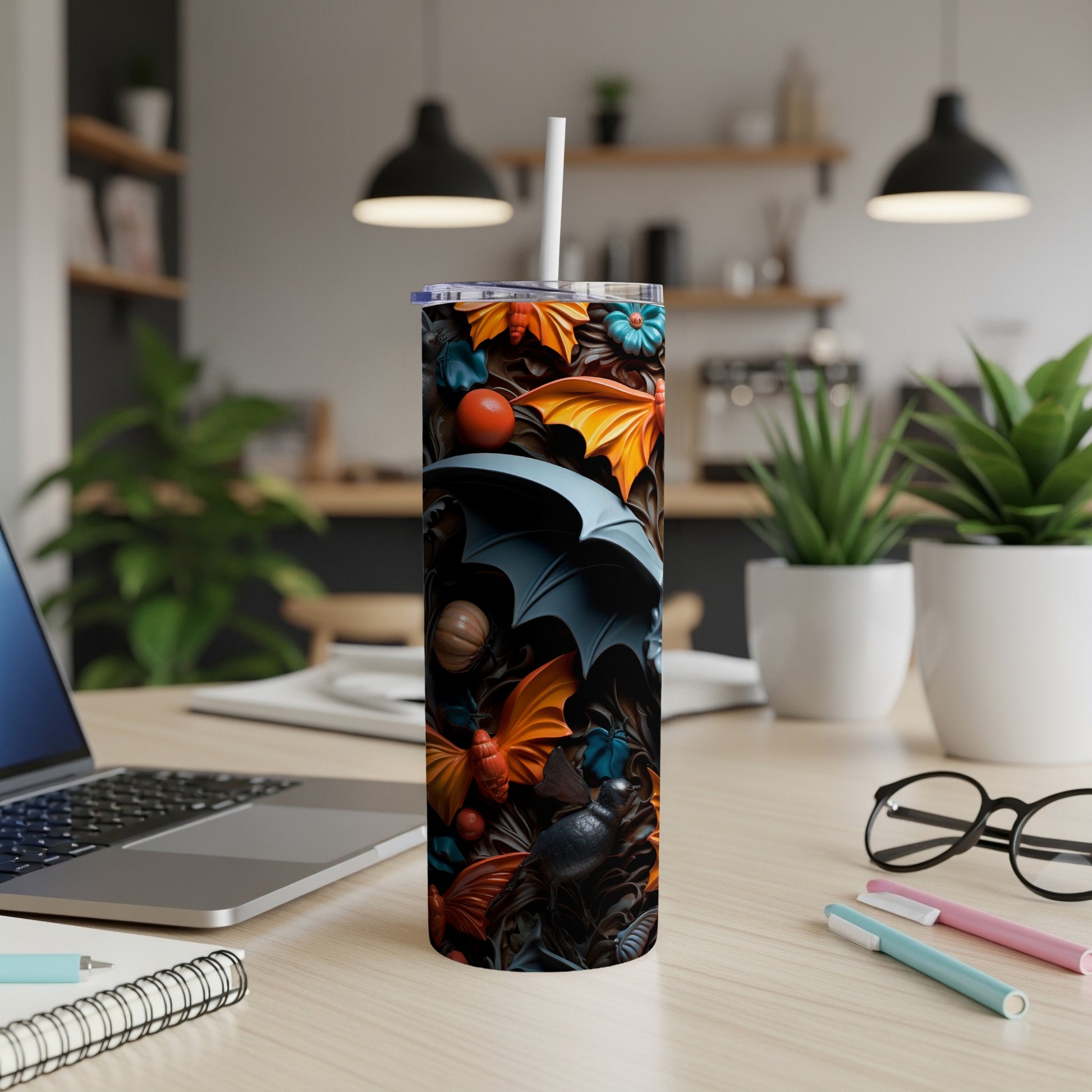 Tumbler with a dark Halloween-themed pattern of bats, pumpkins, and autumn leaves.