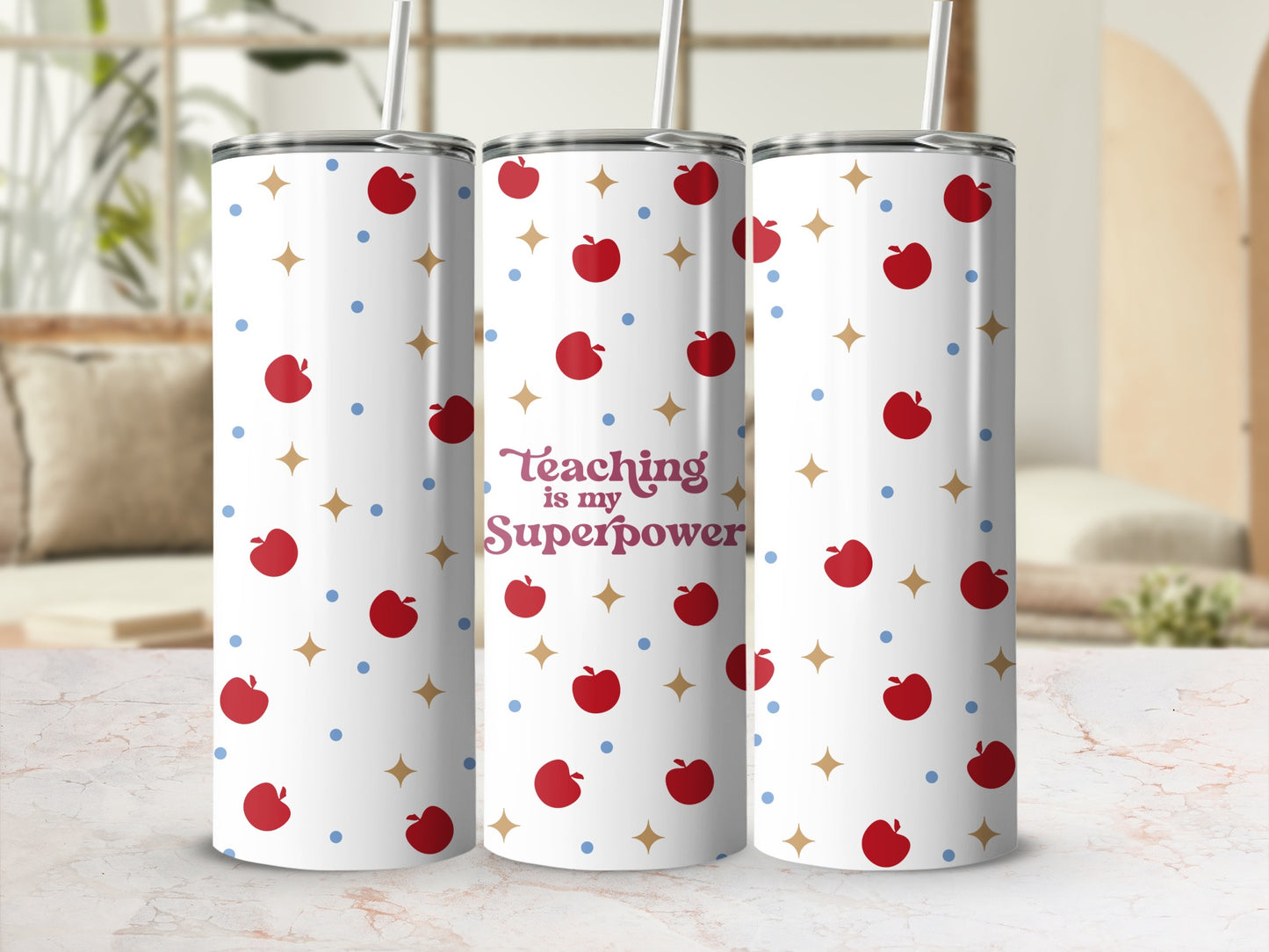 White tumbler with red apples and blue dots, reads "Teaching is my Superpower".