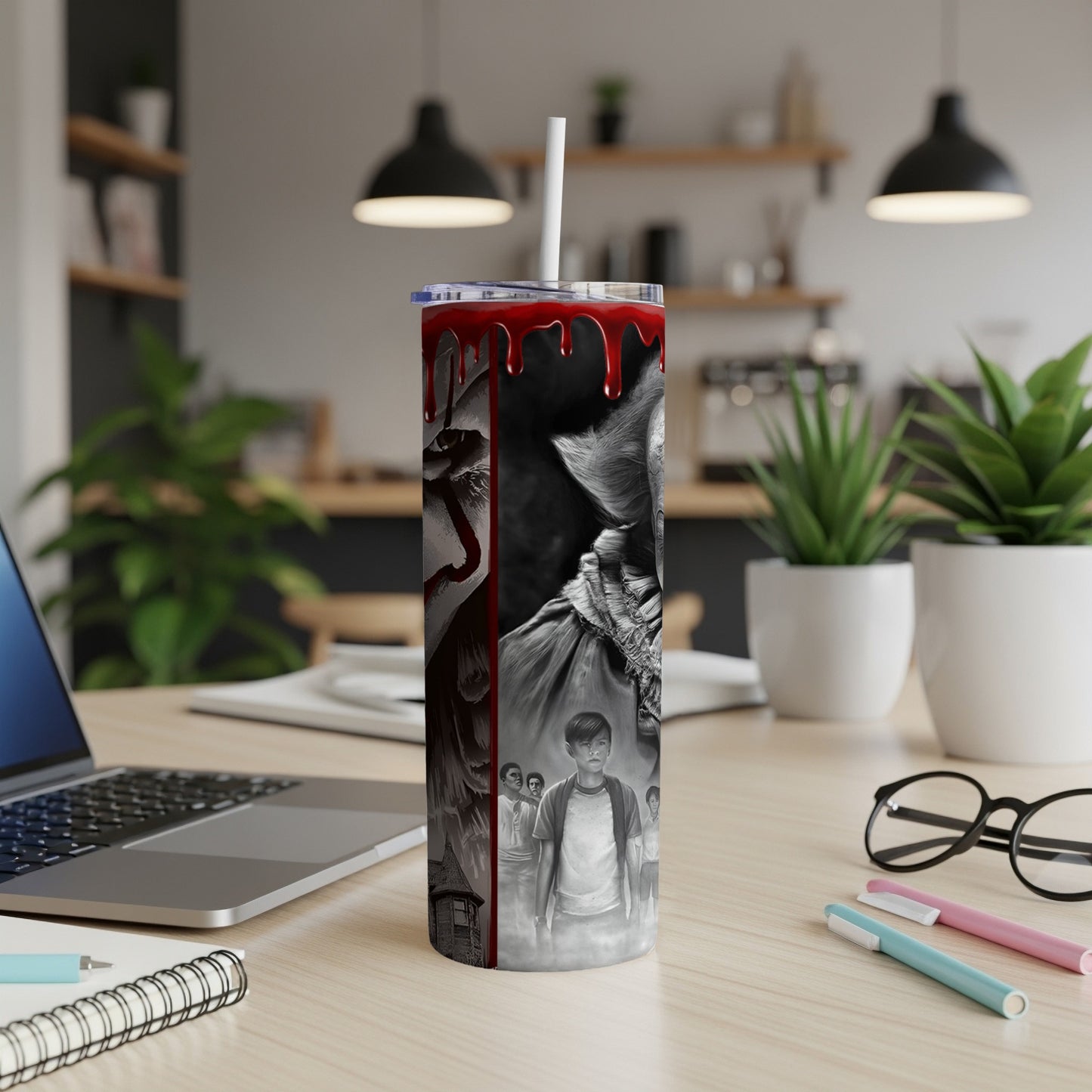 Tumbler with dripping blood and horror movie character illustrations.