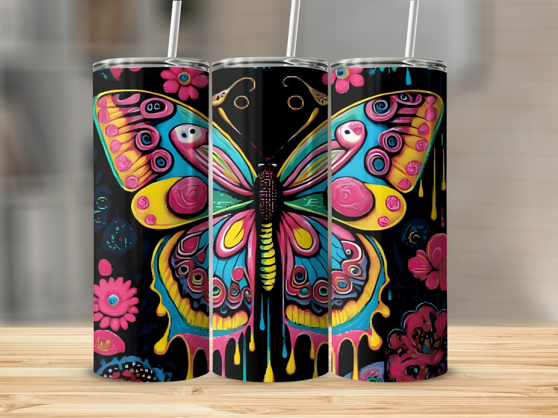 Three tumblers with colorful butterfly and flower designs.