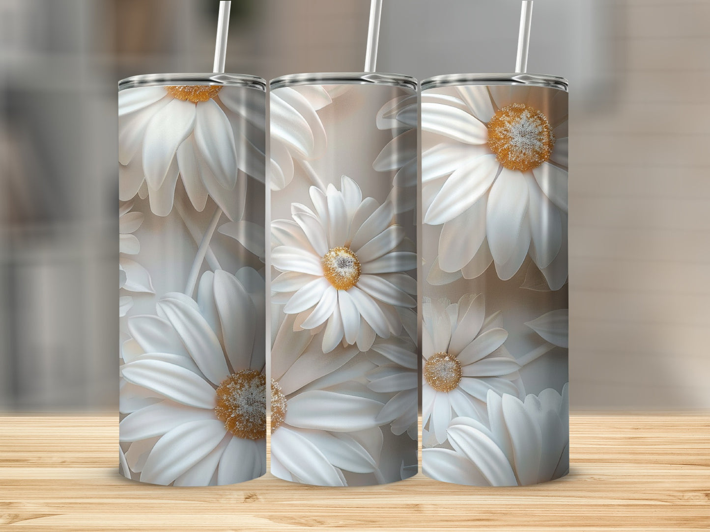 Three tumblers featuring white daisy floral pattern on a wooden surface.