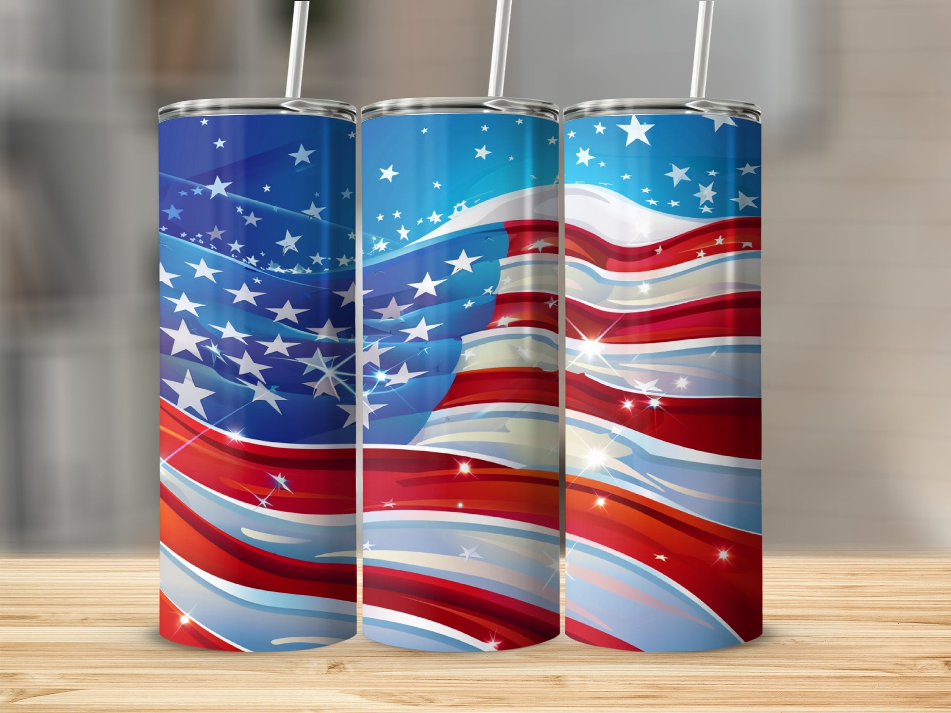 Three tumblers with American flag design, wood background.