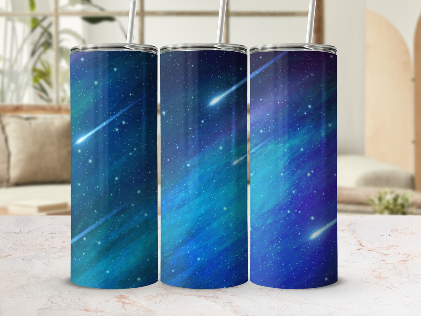 Three tumblers with a blue and green starry night sky and shooting stars design.