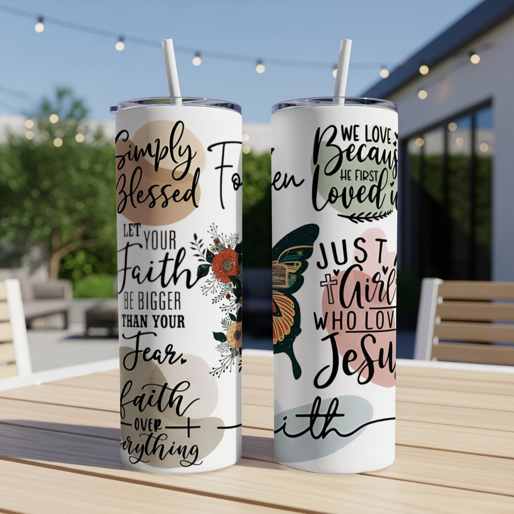 Two tumblers with floral and butterfly designs and religious text.