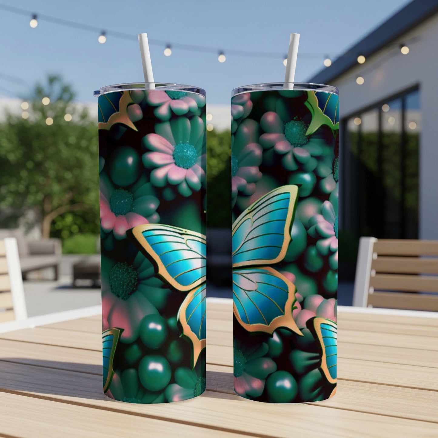 Two tumblers with blue butterfly and floral designs on a wooden table.