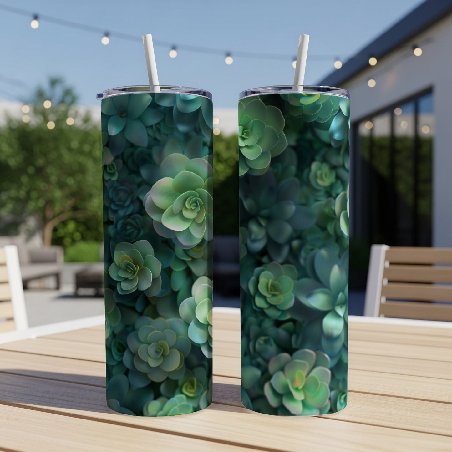 Two tumblers with a dense pattern of green succulents on a patio table.