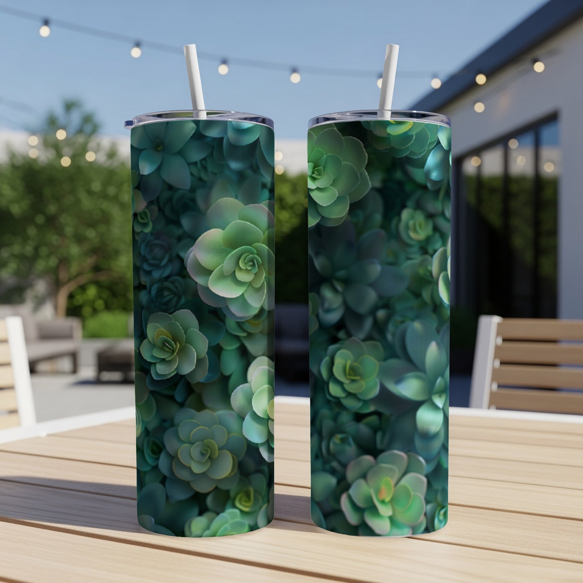 Two tumblers with a dense pattern of green succulents on a patio table.
