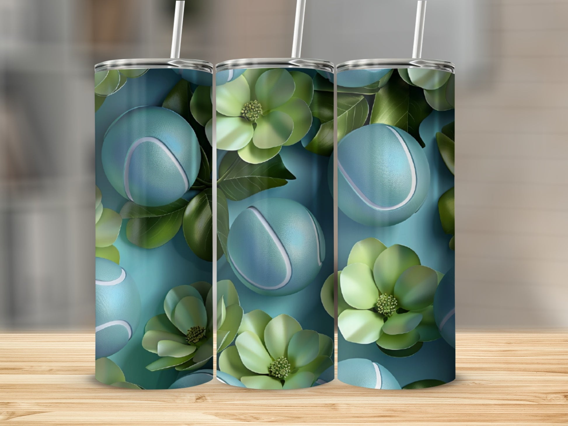 Three teal tennis balls and green floral accents on a skinny tumbler.