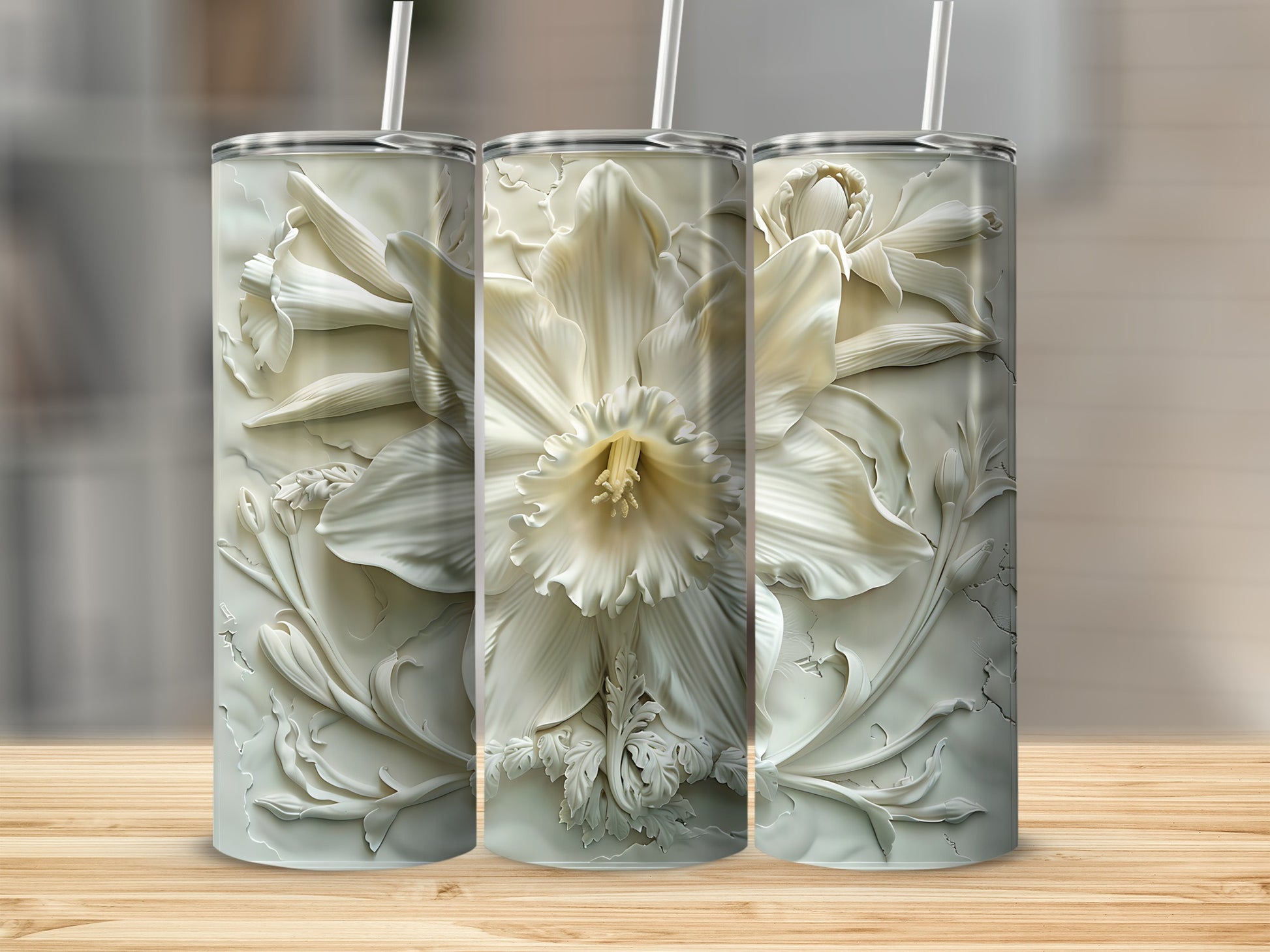 White floral embossed tumblers with straws on a wooden surface.
