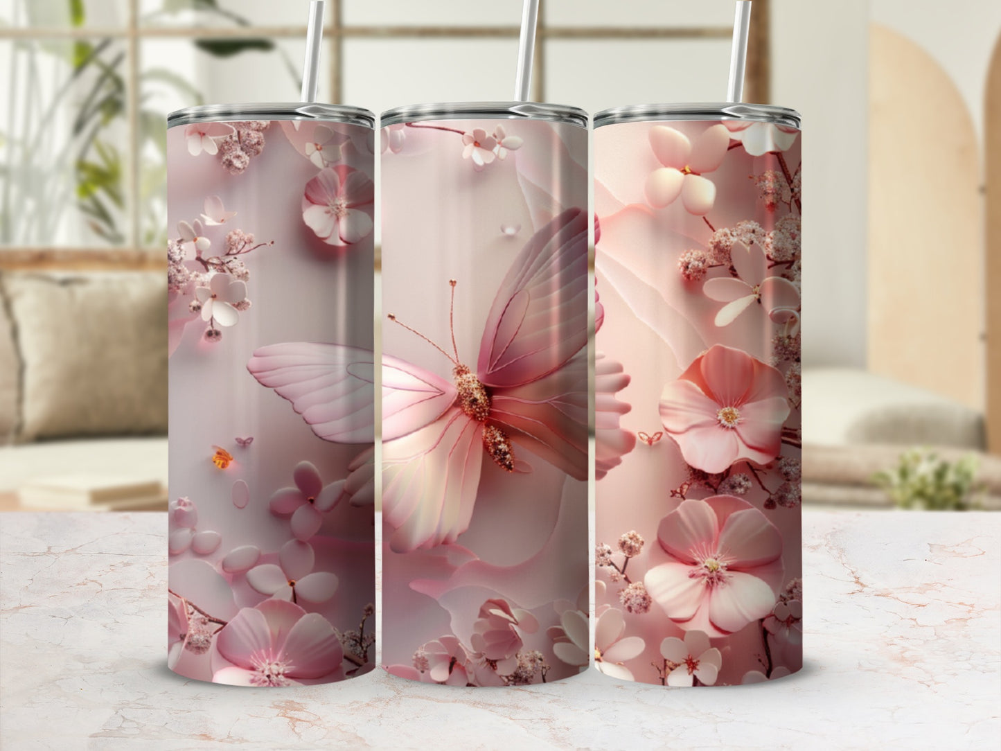 Pink floral and butterfly design on three insulated tumblers.