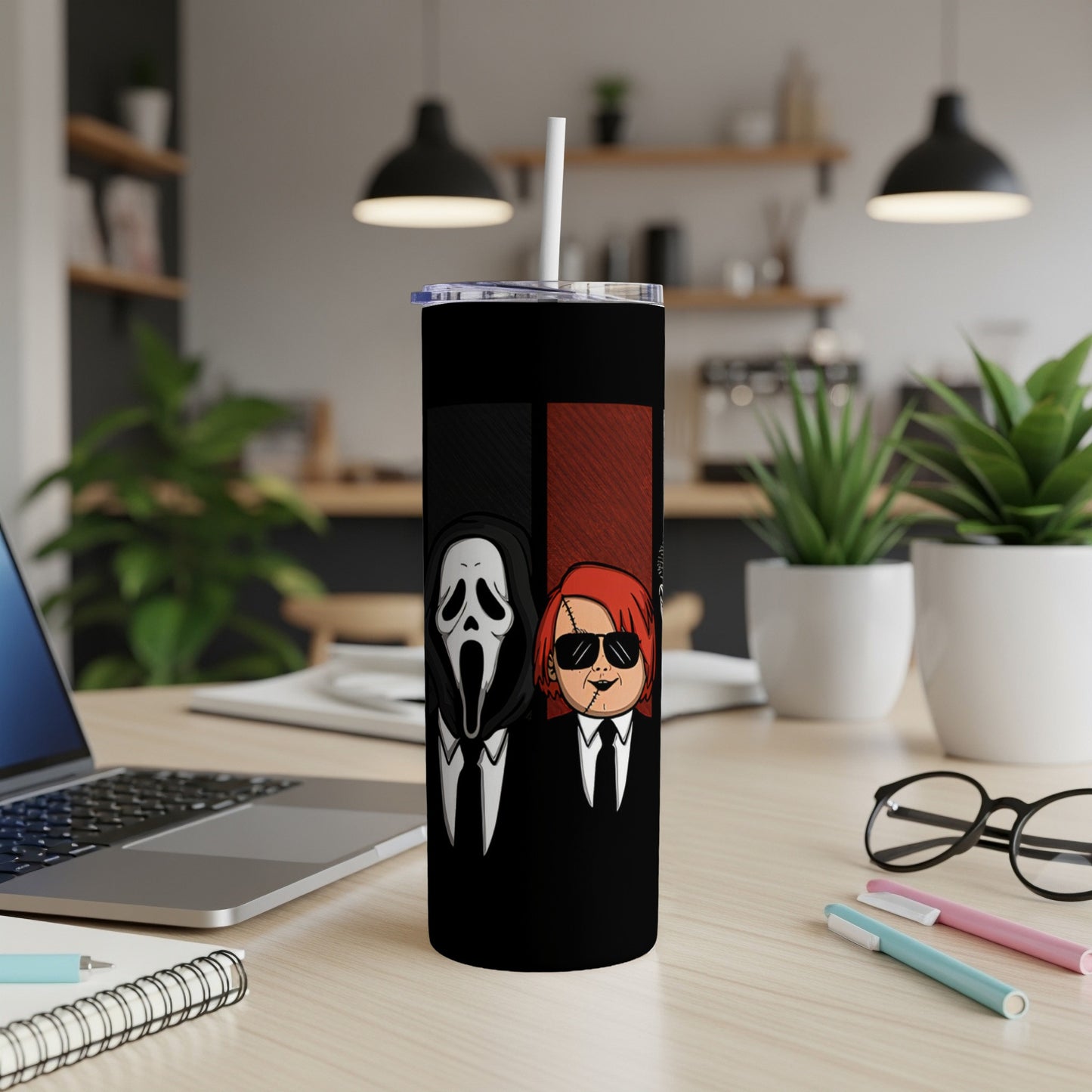 Scream mask and Chucky characters on a black tumbler with a straw.