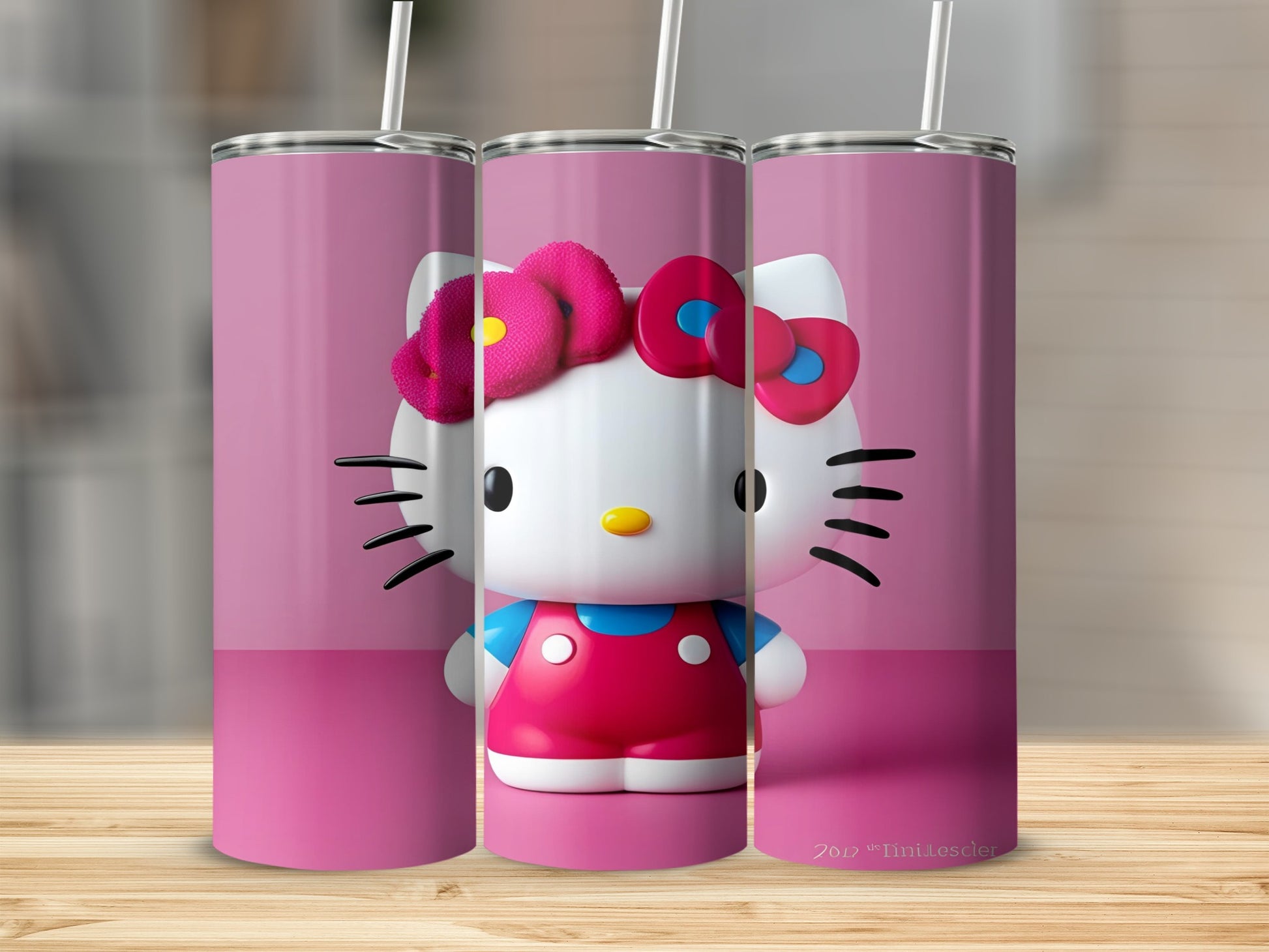 Three Hello Kitty tumblers with pink backgrounds and straw details.