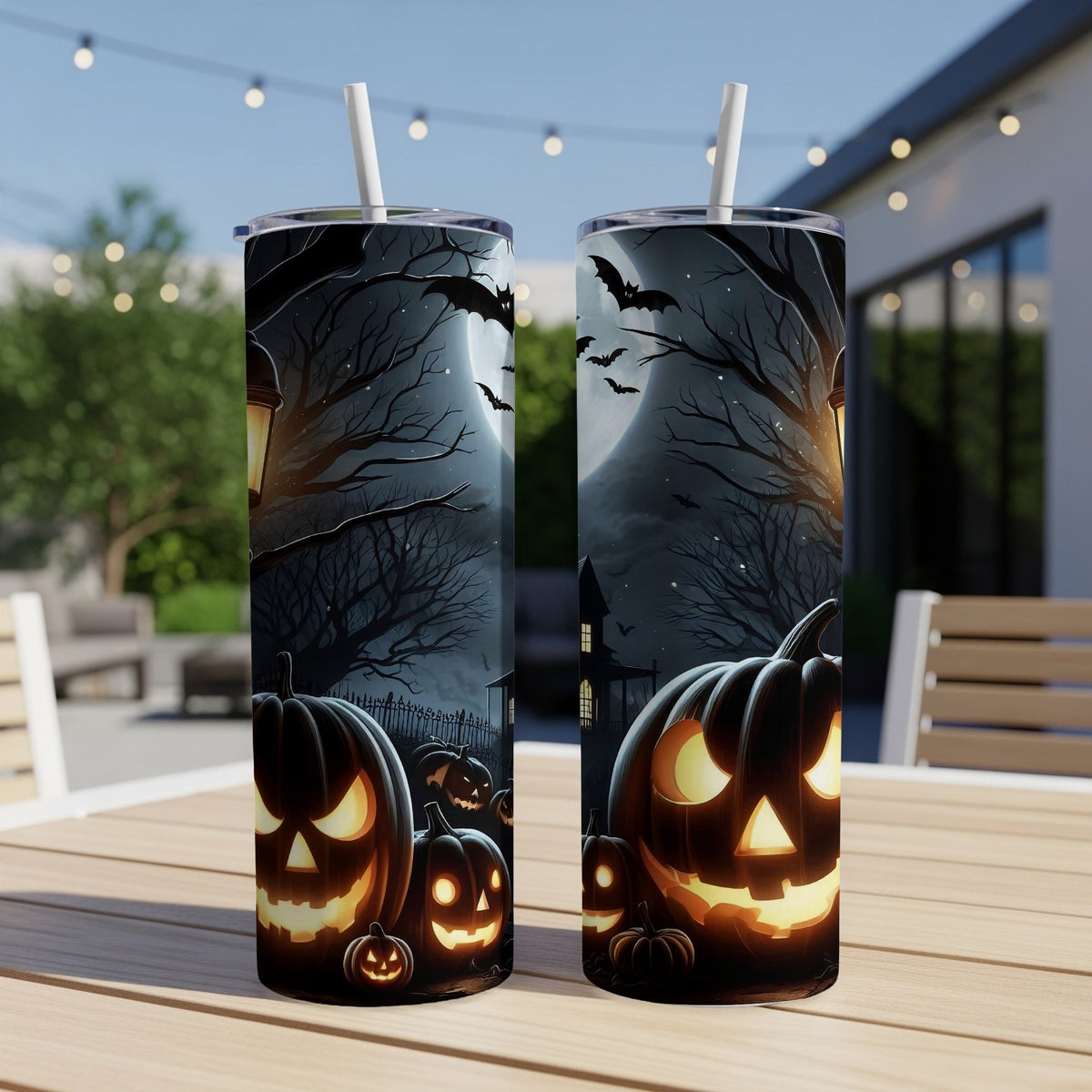 Two tumblers with a spooky Halloween scene featuring jack-o'-lanterns, bats, and a haunted house.