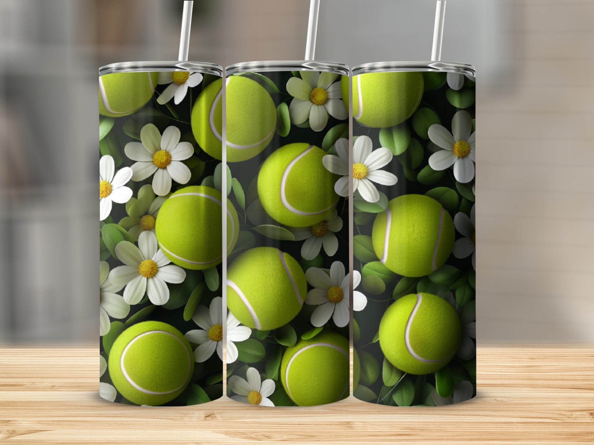 Tennis balls and white flowers on a green background, displayed on three tumblers.