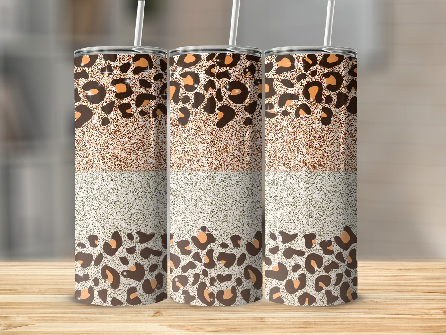 Three tumblers with leopard print and glitter patterns.