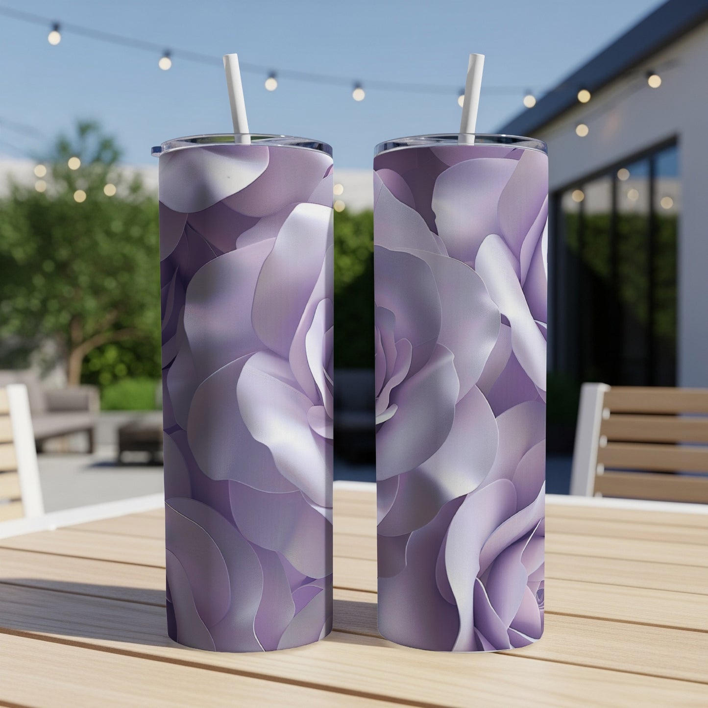 Two tall tumblers with purple rose petal designs sit on a wooden table.