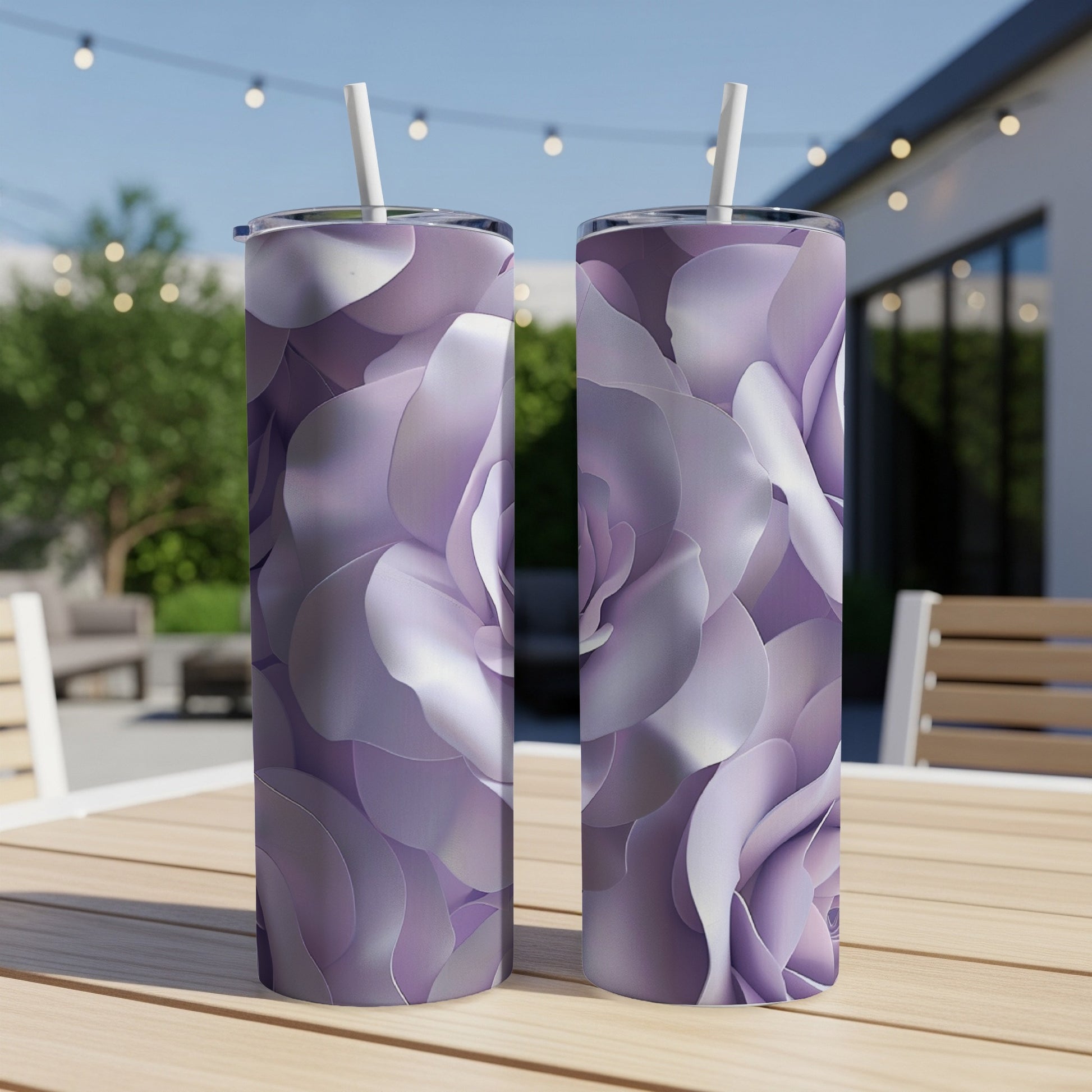 Two tall tumblers with purple rose petal designs sit on a wooden table.