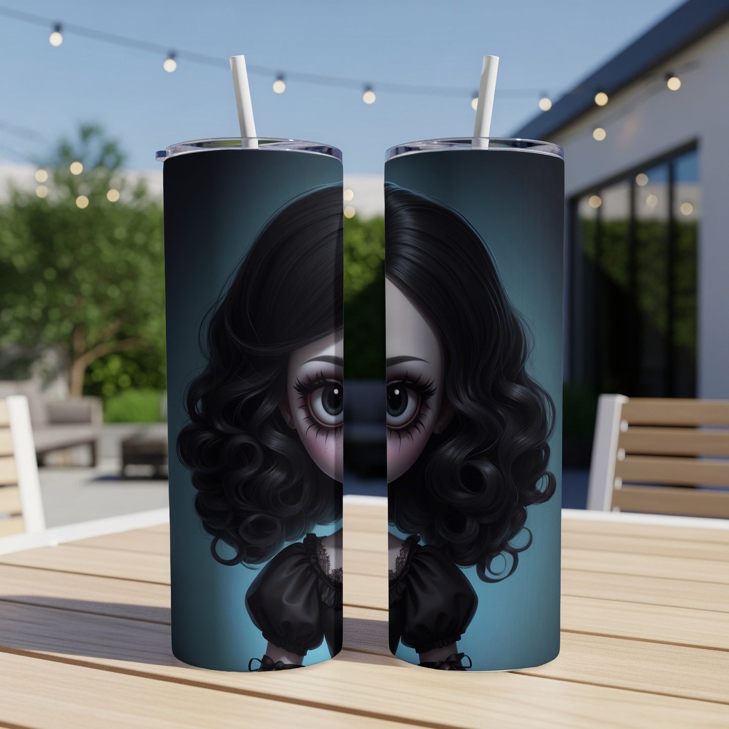 Two tumblers with a spooky doll face design on a wooden table.
