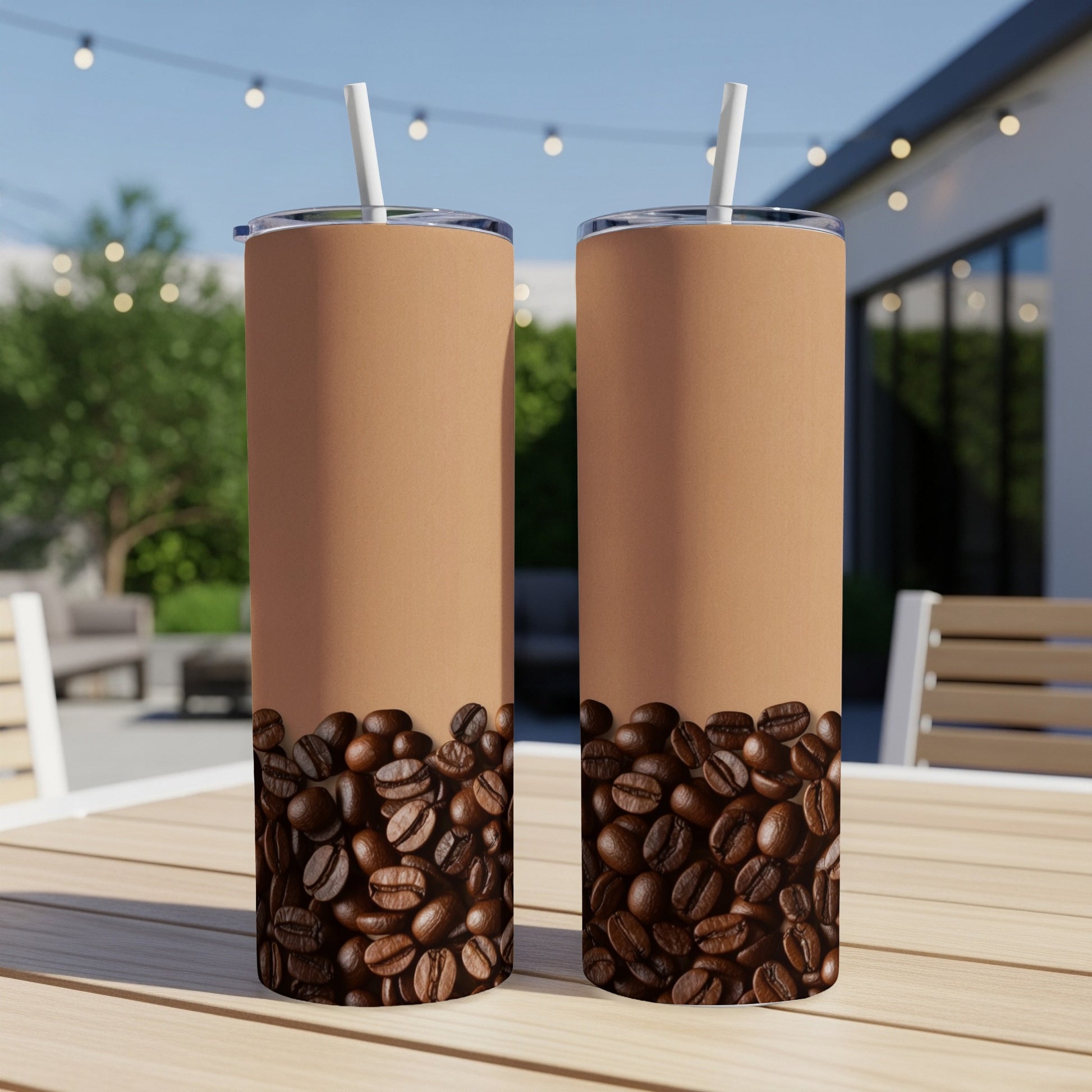 Two coffee tumblers with coffee bean design and brown top, on a table.