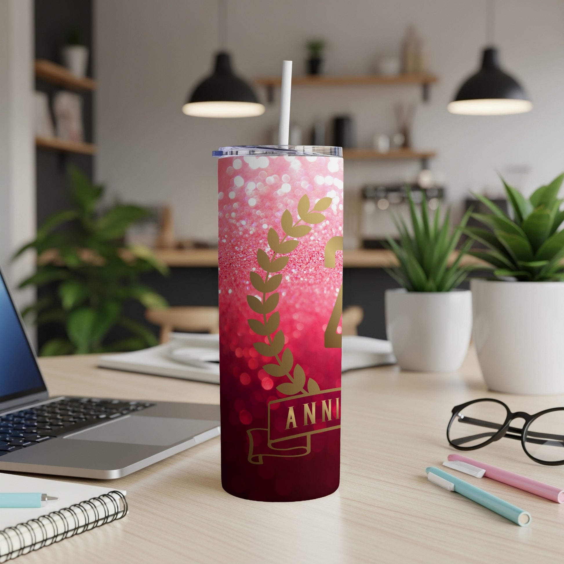 Glittery red tumbler with "24 ANNIVERSARY" text and gold leaf design.