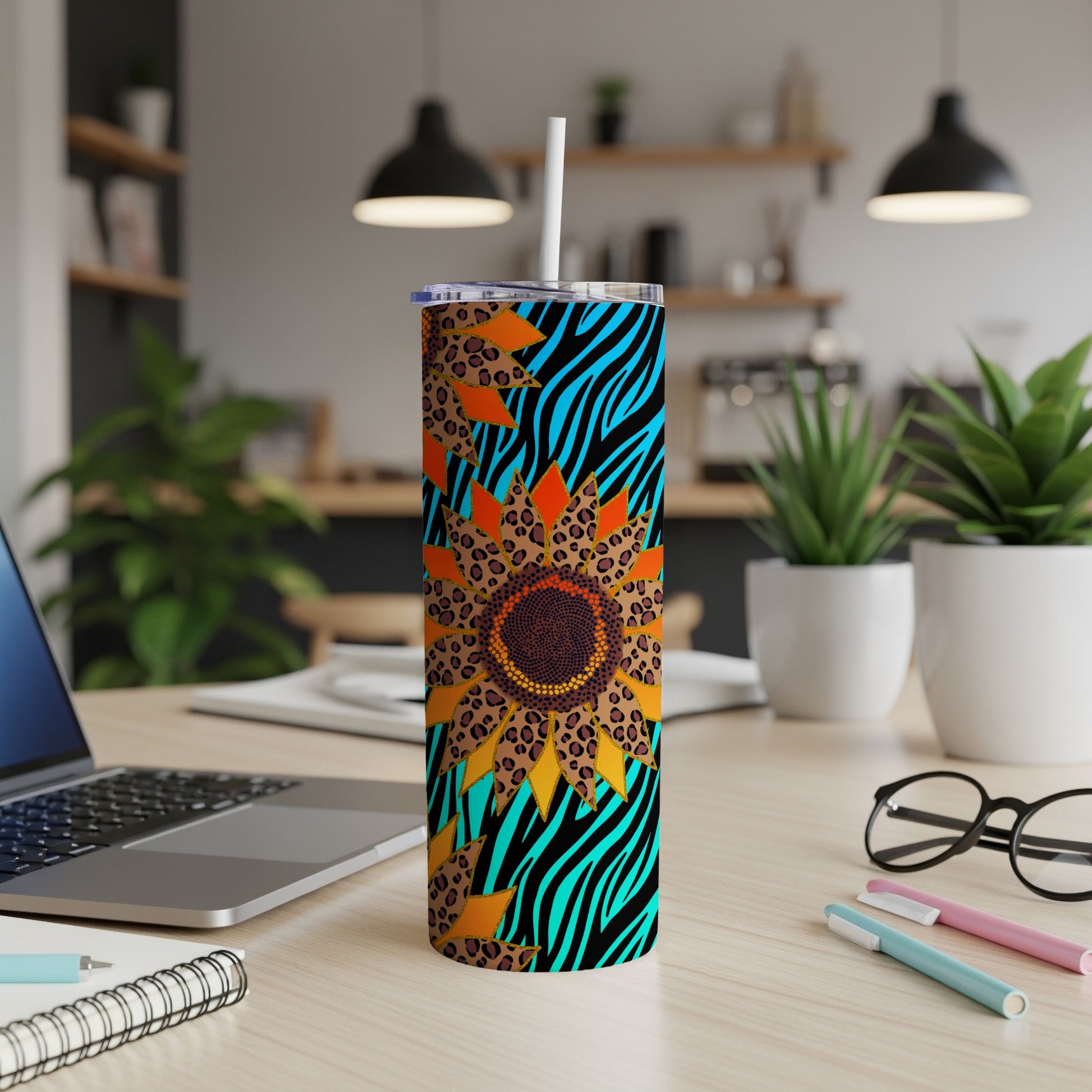 Sunflower tumbler with blue and black zebra print and leopard spots.